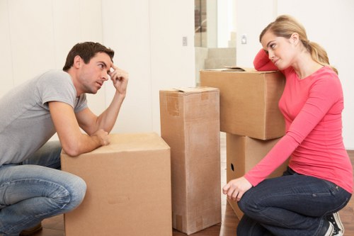Two movers handling boxes and furniture for a Soho delivery