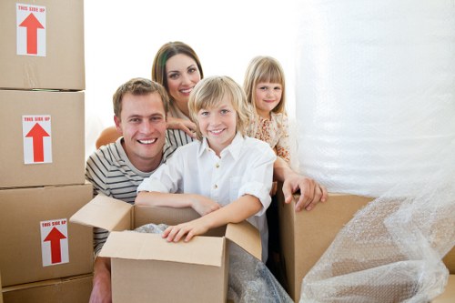 Movers using protective packing and handling equipment during a removal van job